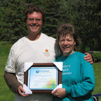 Cathy Nesbitt accepts Environmental learning award from Brent Kopperson of Windfall Ecology Centre